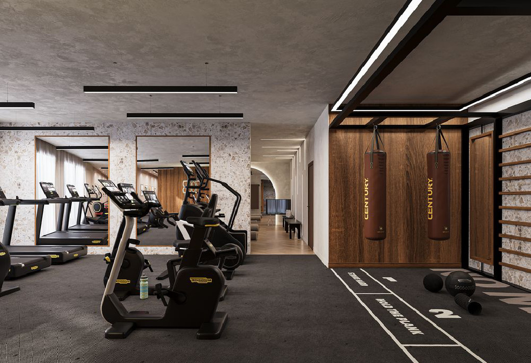 Espace fitness équipé de vélos, tapis de course et sacs de frappe